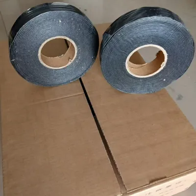 Repairing road cracks with self-adhesive sealing strips for patching and sealing.