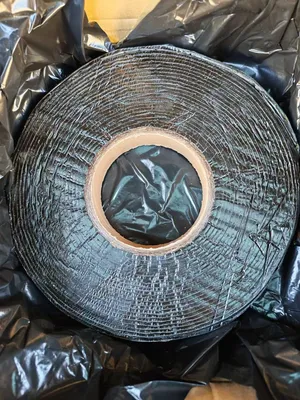 Treatment of cracks on asphalt and cement pavement using seam tape